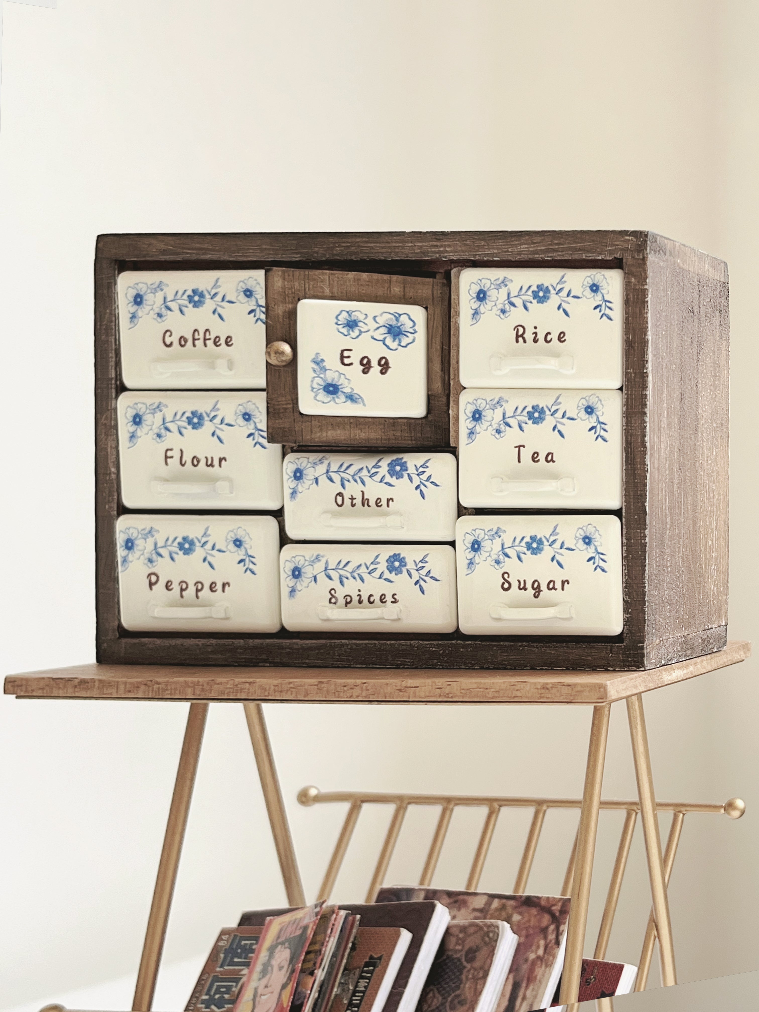 Antler Brown spice cabinet displayed on gold side rack with center Egg door open

